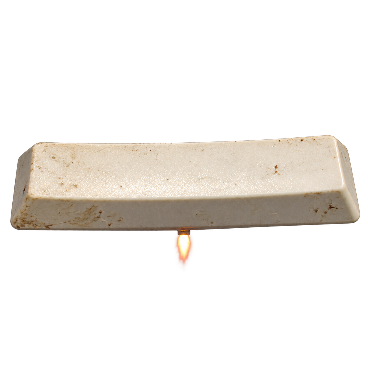 A grubby, off-white space key with a tiny rocket flame.